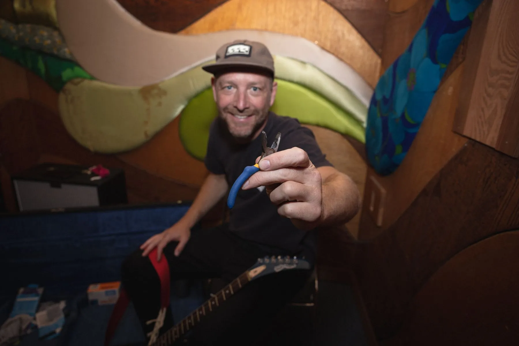 Guitarist grinning in the painted booth